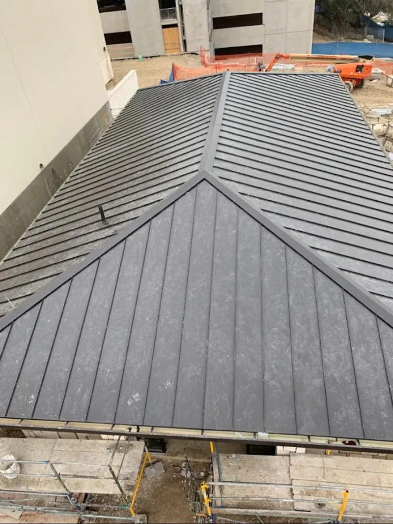 Commercial metal roof construction with crane equipment in Green Cove Springs