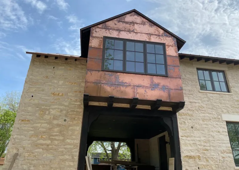 Copper metal panel facade on a stone building for Skylight Installation in Green Cove Springs